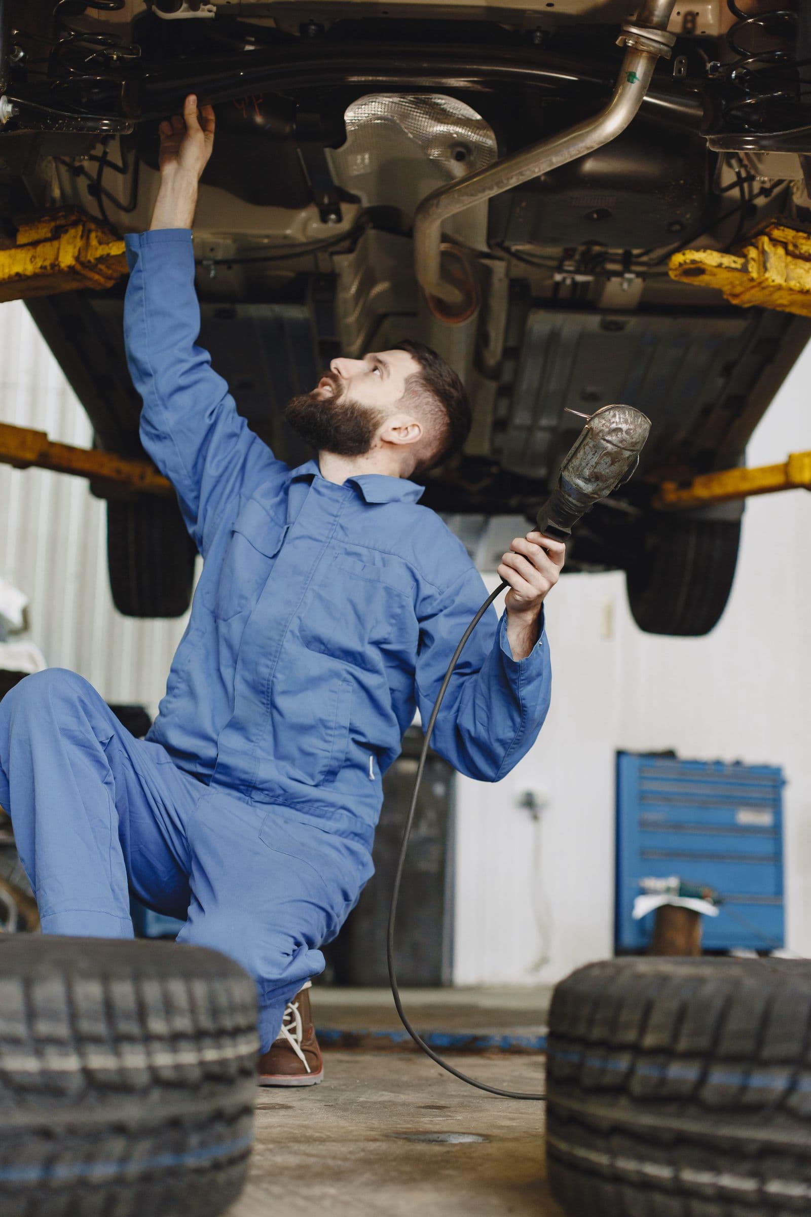 Mechanic working under a lifted vehicle